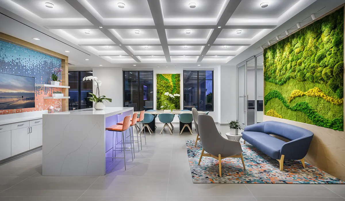 Bright and contemporary office design featuring a moss wall, vibrant furniture, and a sleek workspace layout for engineering projects.