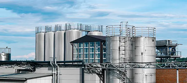 Skyline image showing the upper fragment of a modern industrial production manufacturing operation featuring exterior bunker storage.